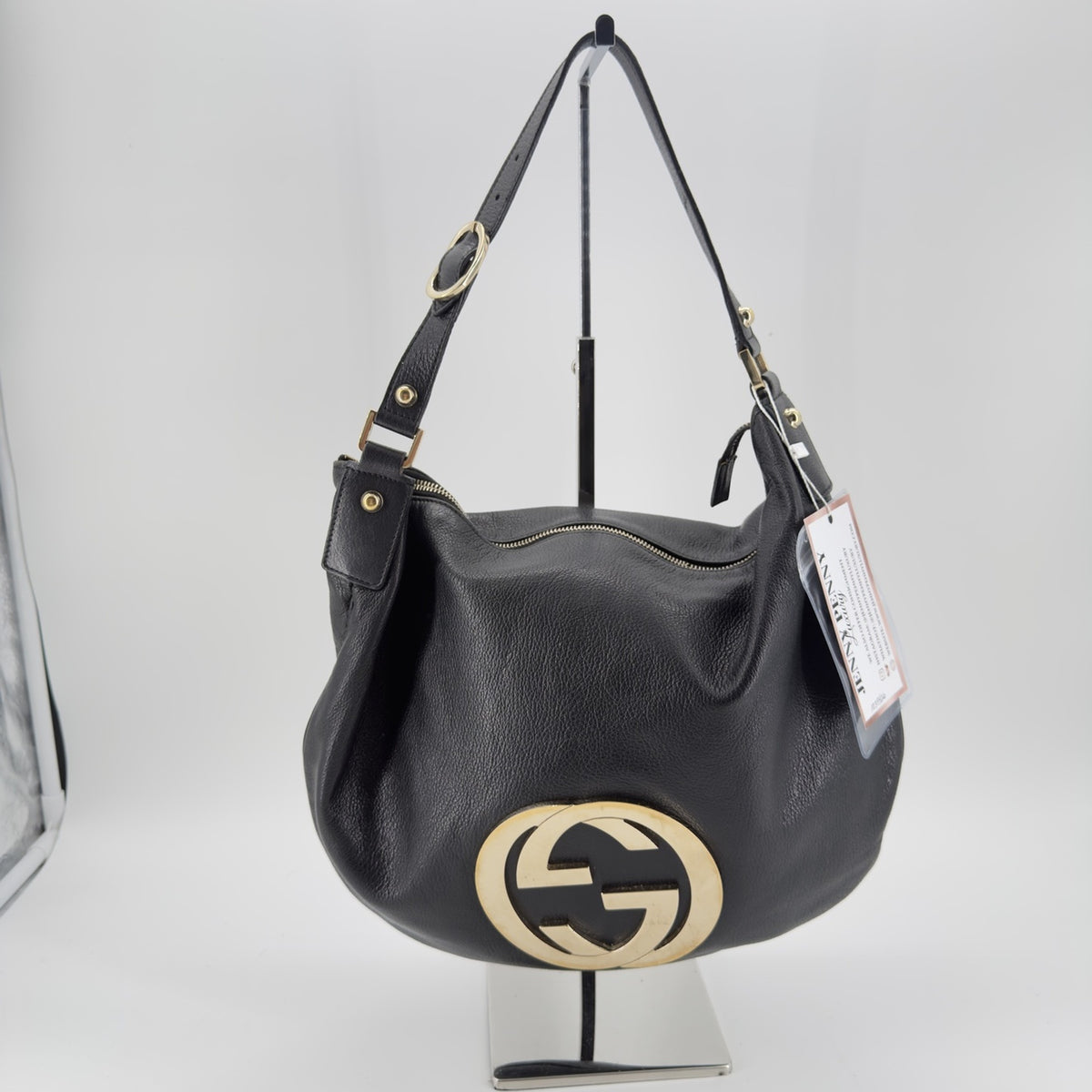 Front view of black pebbled leather Gucci hobo shoulder bag with large gold-tone interlocking GG logo