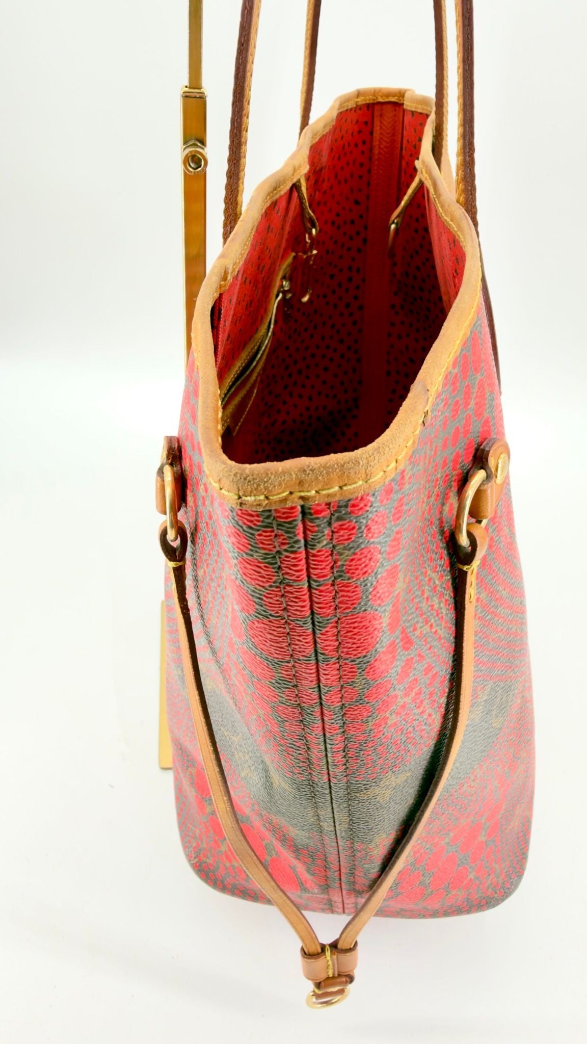 Kusama Neverfull opposite side, cinched, red interior visible