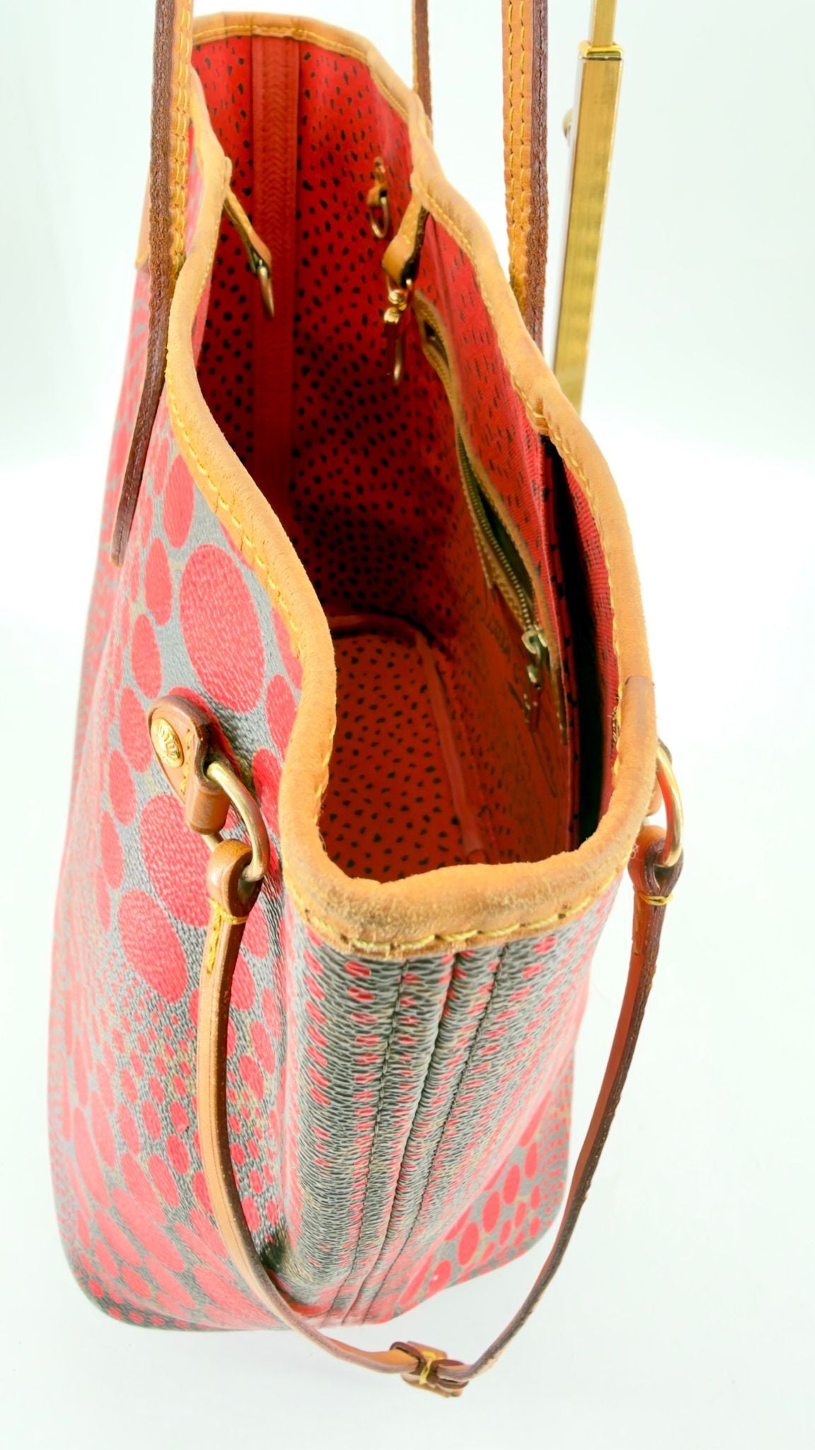 Kusama Neverfull angled side view showing red interior