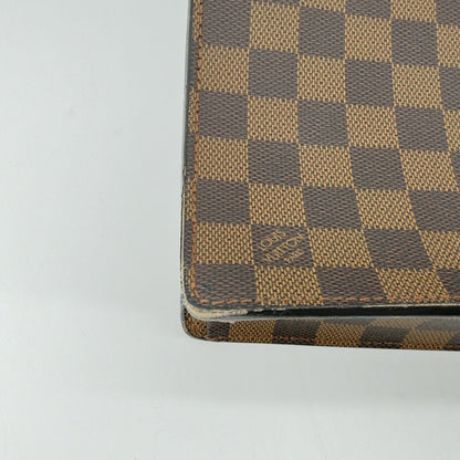 Close-up detail of minor corner rubs on Damier Ebene Serviette Conseiller briefcase
