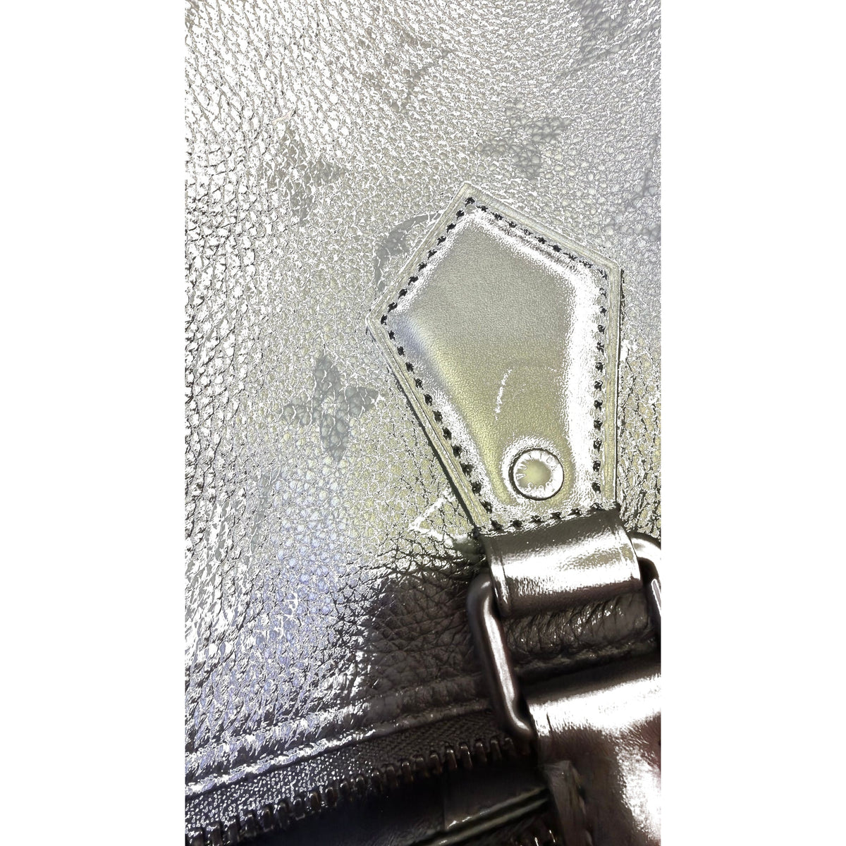 Close-up of handle mount tab with LV-stamped rivet and chunky hardware