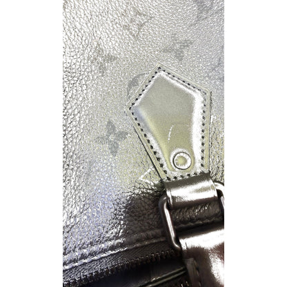 Close-up of handle mount tab with LV-stamped rivet and chunky hardware